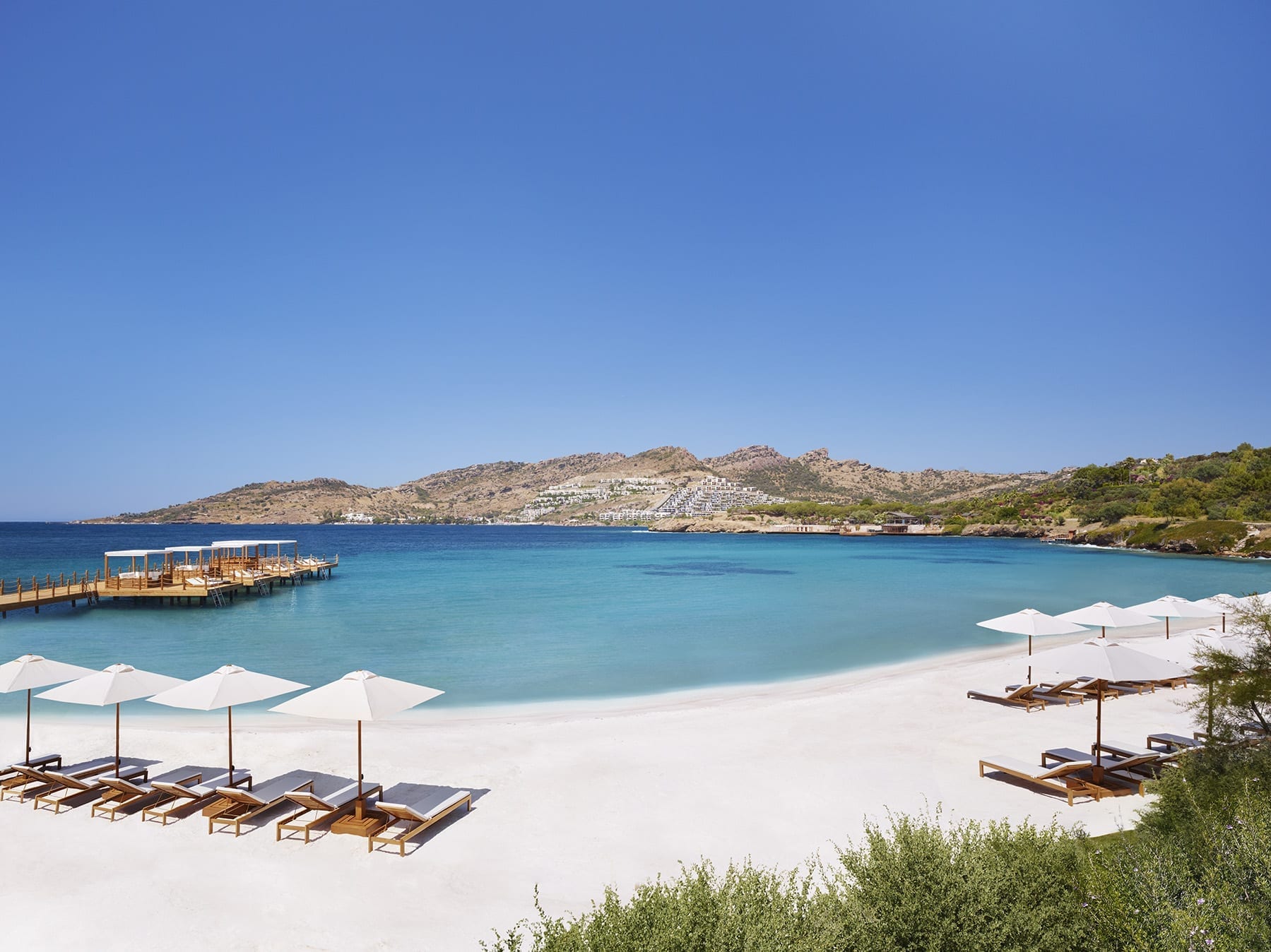 chaise loungers with umbrellas at the Beach Club