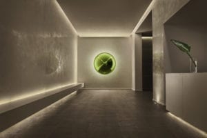 Hotel entrance with recessed lighting and central art piece