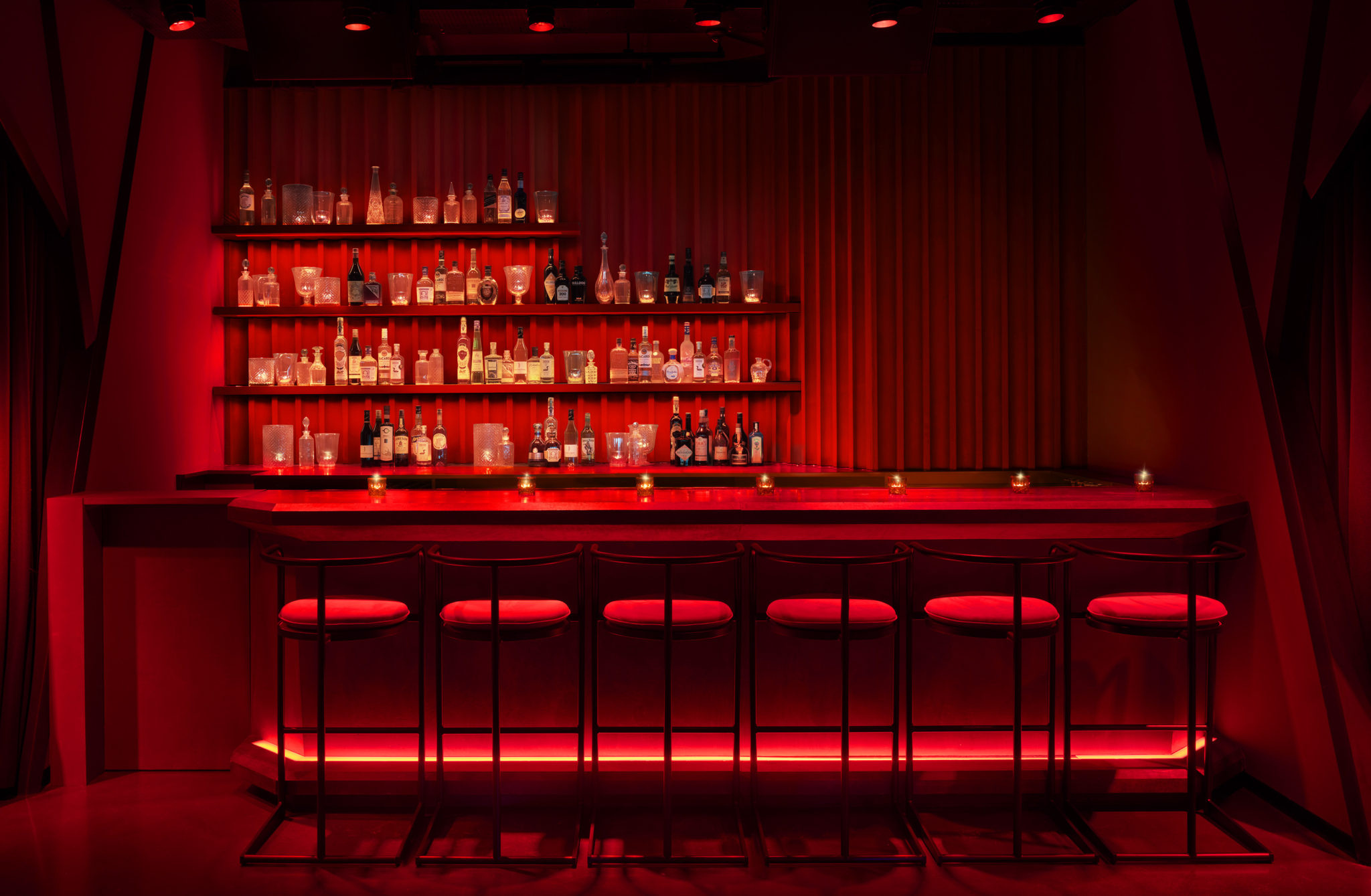 All red bar lined with stools