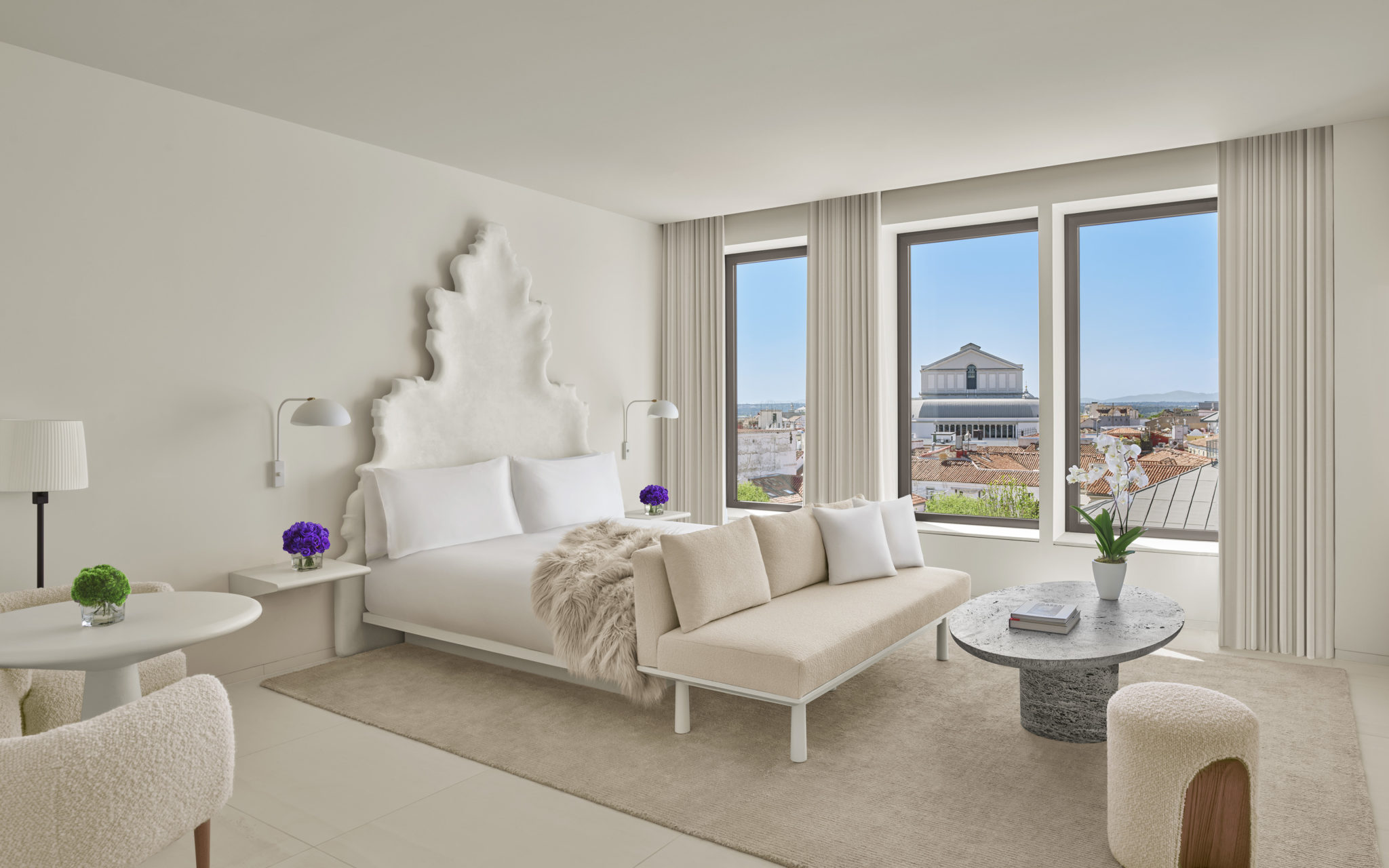 Light-colored guest room with large windows