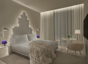 Stylish guest room with fur throw on bed	