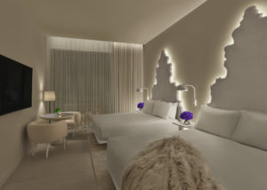 All white guest room with backlit headboards