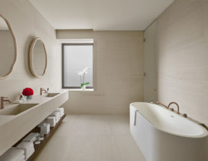 White marble bathroom with deep bathtub