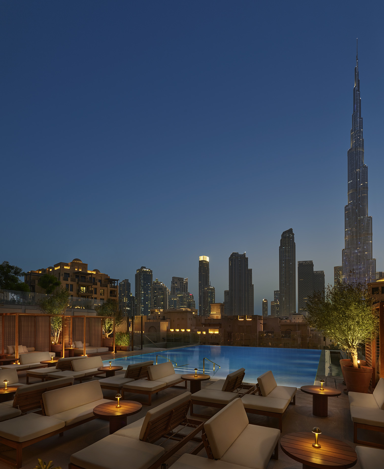 Pool deck at night with city view