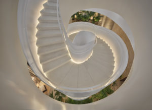 Looking down a white spiral staircase