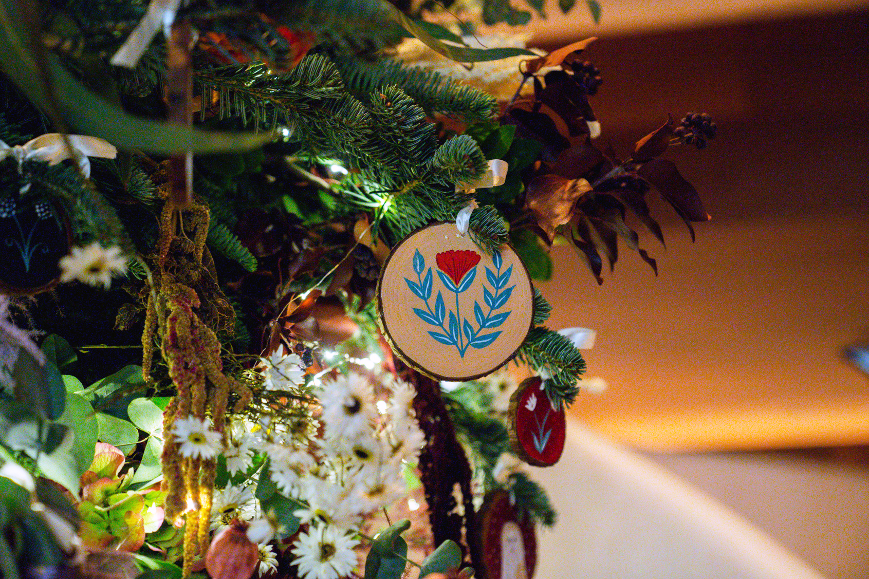 Close-up of ornaments handing on pine branches