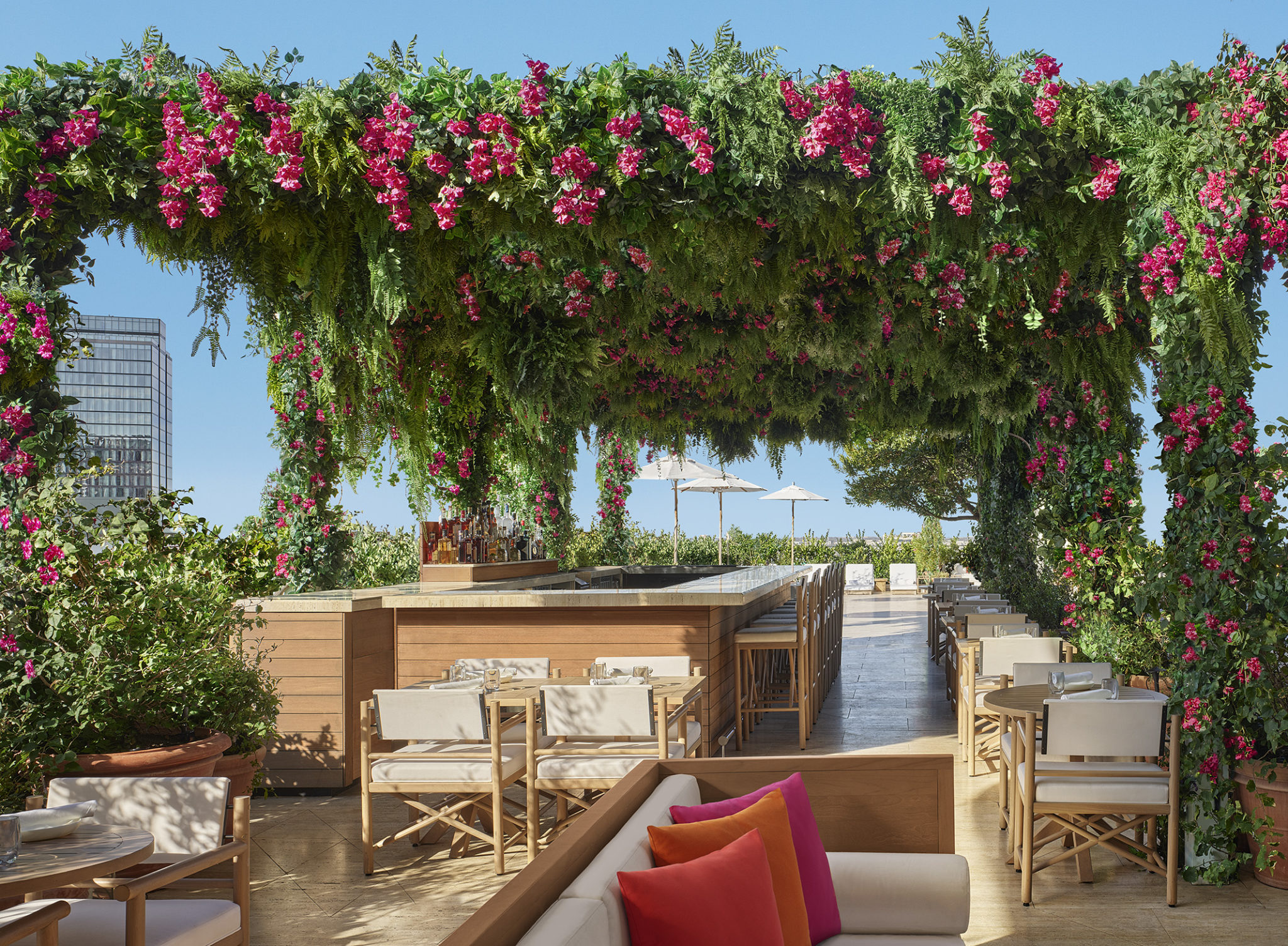 Outdoor bar covered with roof of floral vines