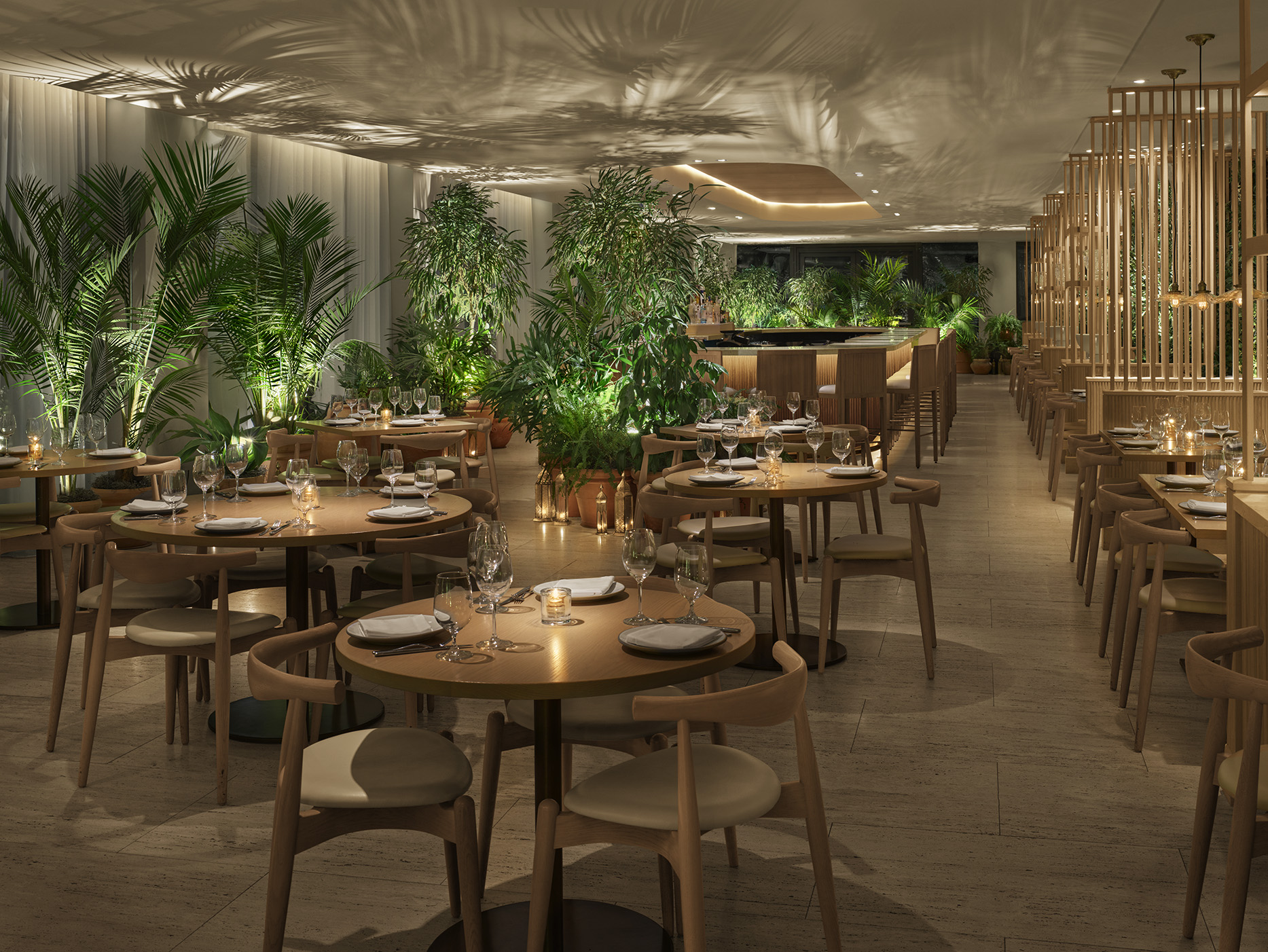 Restaurant designed with light wood and tropical flora