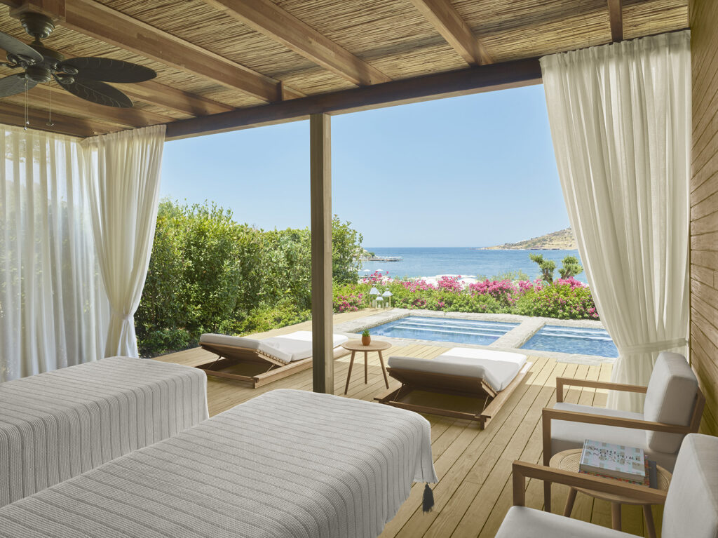 Waterfront view featuring two white massage tables and a small pool