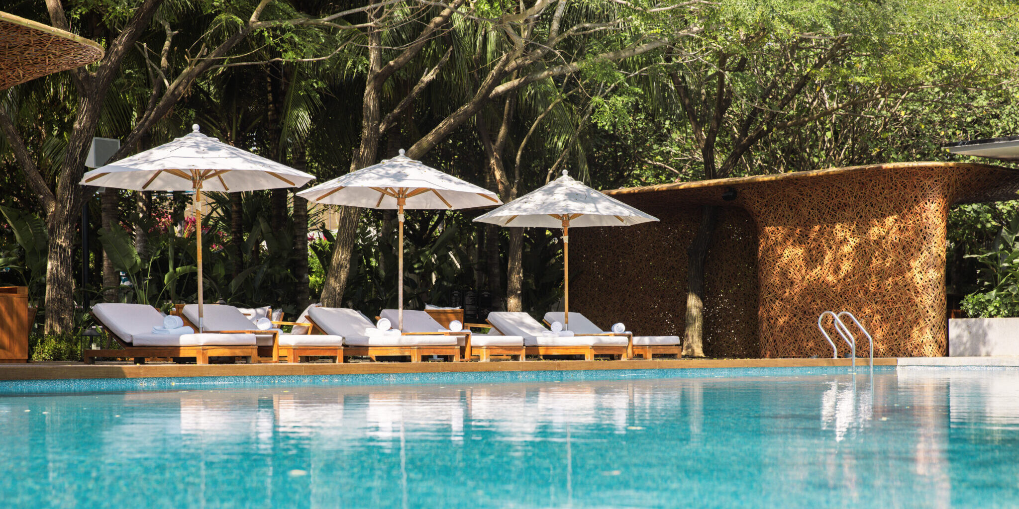 A pool with several chairs poolside