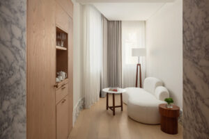 The couch, mini bar and room details of the Loft