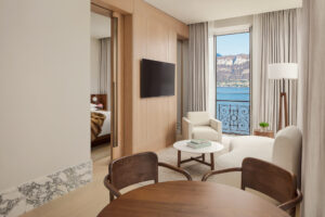 Warm wood and sculptural furnishings shape a calming living space, while the Loft Suite with Lake View opens directly onto sweeping panoramas of Lake Como.